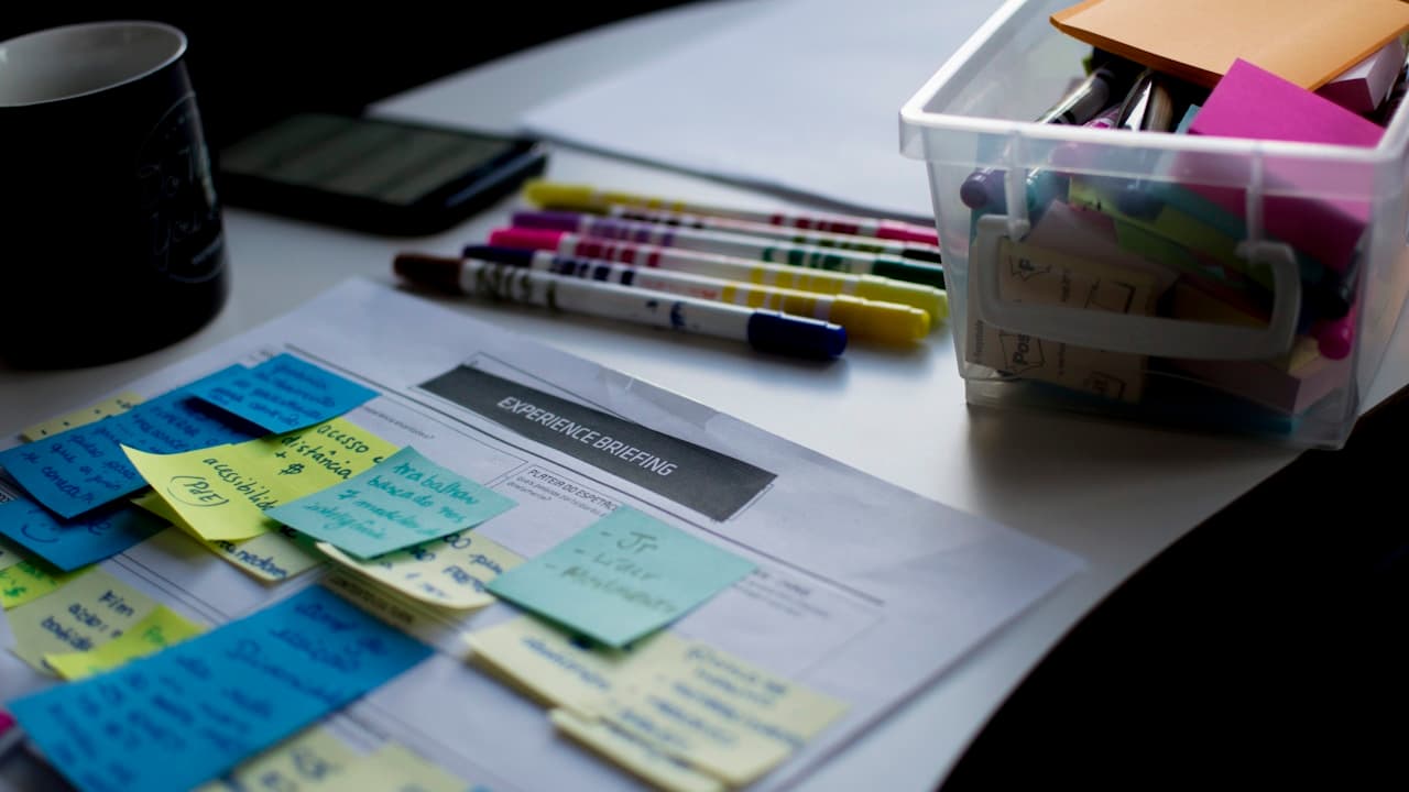 Strategy planning desk with colorful sticky notes, markers and printed notes for brainstorming