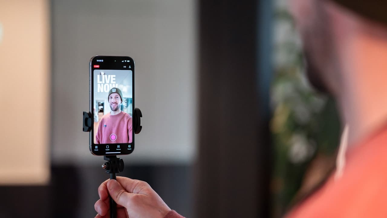 Creator going live on a phone mounted on a tripod