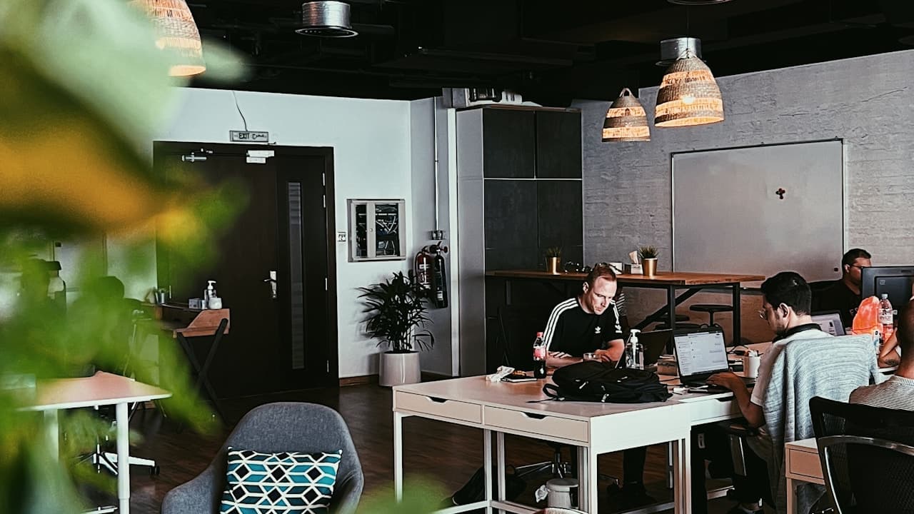 Marketing agency team working together on laptops in a modern open office space