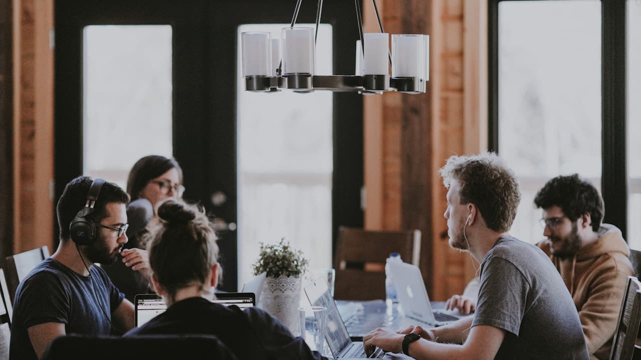 Diverse team collaborating around a table on a campaign