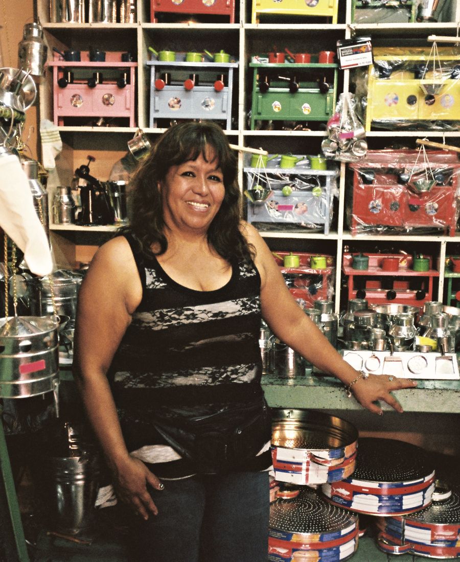 Seller in a shop full of merchandise