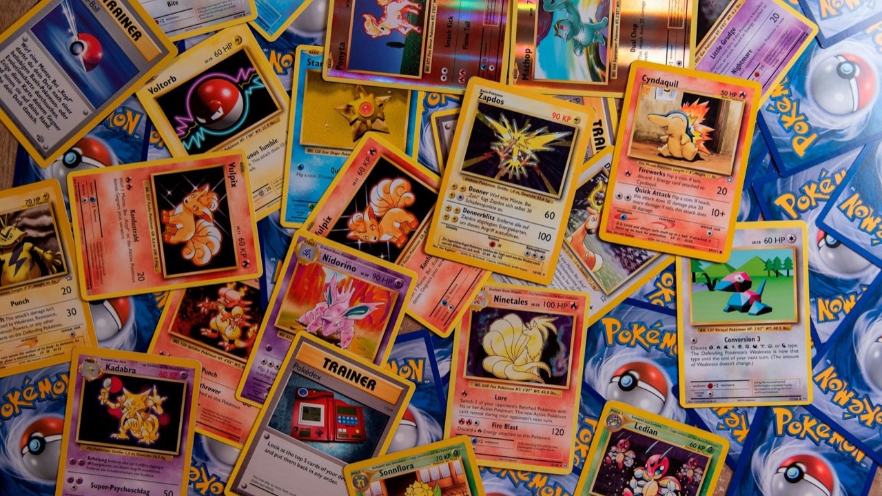 Vintage Pokémon trading cards spread across a table